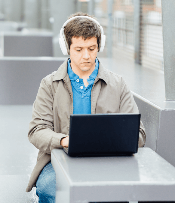 Young man working on a laptop, emphasizing ATA-certified transcription services for trusted and precise documentation. Young man working on a laptop, emphasizing ATA-certified transcription services for trusted and precise documentation.