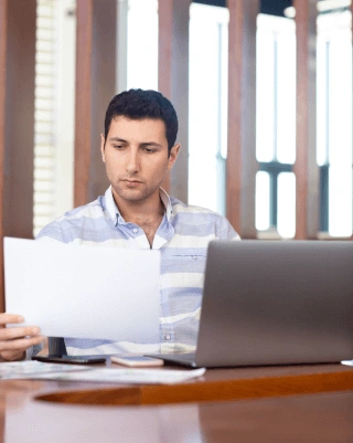 Professional examining translated business documents to accuracy for successful international communication & operations.