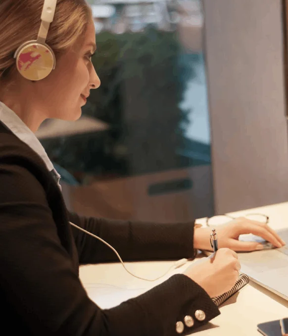 A transcriber uses Irish Transcription Services to produce clear transcripts, correcting names and punctuation for review.