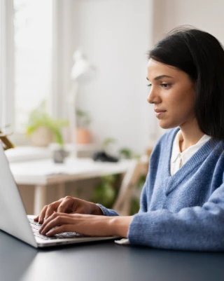 A staff member performs Fast Typing Services with secure data entry on a locked laptop and encrypted drive.