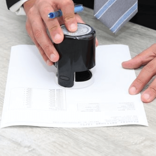 Certified transcriptionist stamping a paper transcript Certified transcriptionist stamping a paper transcript