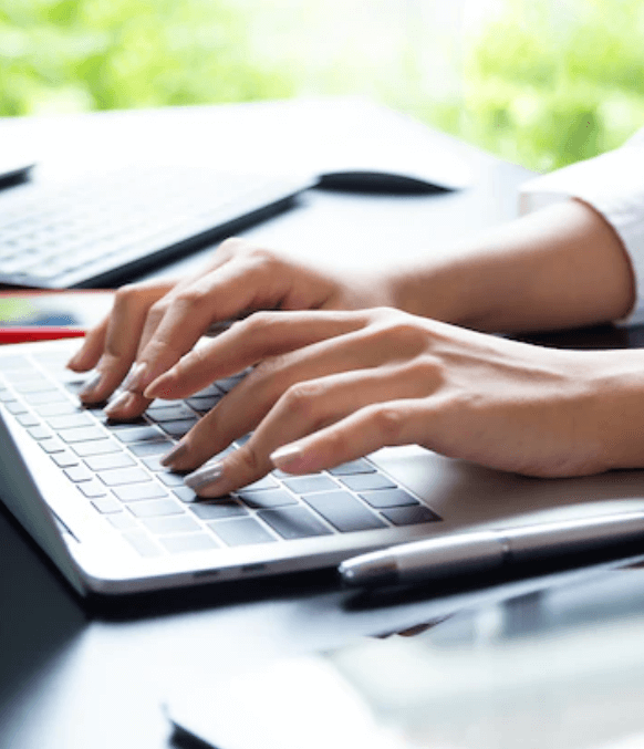 Hands of a female transcriptionist typing on her laptop Hands of a female transcriptionist typing on her laptop