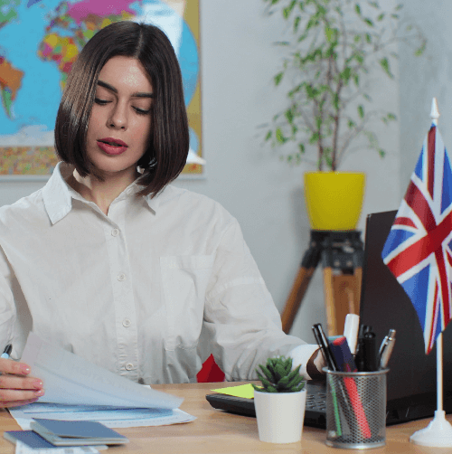 Professional woman with a world map background, highlighting international language services for cultural connection. Professional woman with a world map background, highlighting international language services for cultural connection.