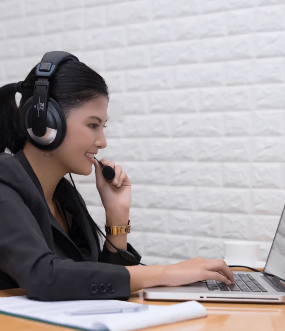 A captioning expert in Seattle typing subtitles for a client's video using closed-captioning services in Seattle.