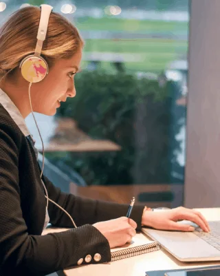 A transcriptionist uses a headset and foot pedal as Irving Transcription Services creates fast, secure audio transcripts.