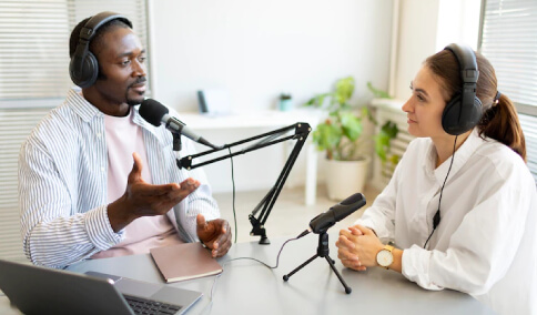 A man and woman talking in a podcast