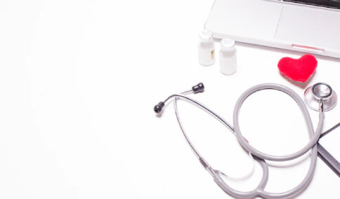 A Laptop and a Stethoscope on the Table
