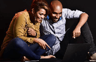 A man and woman happily watching a video with a transcript