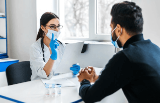 A female doctor consults her patient and holds documents in her hands