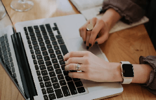 An expert female transcriber working on laptop