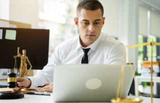 A transcriptionist works on a laptop, ensuring confidential legal transcription services in Albuquerque for accurate.