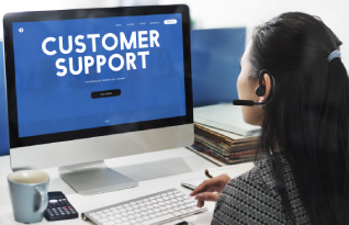 A professional working on the laptop, representing comprehensive customer support and high-quality transcription services.