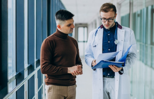 Doctor talking with his patient at clinic
