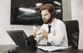Transcriber working on a laptop. Industry-specific Plano transcription services for business and legal documentation.