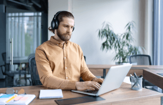Focused professional wearing headphones, offering industry-compliant transcription services in San Francisco.
