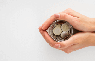 Person holding a jar with coins