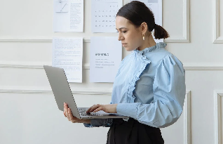 Transcriber standing with laptop