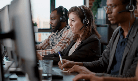 Transcribers at office, using audio headsets and computers