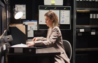 Transcriptionist reviewing secure records on a table for reliable and secure transcription services for diverse industries.