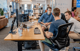 Three transcribers sitting together in discussing a project