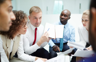A diverse group of professional transcriptionists  engaged in a conference discussion in Seattle.