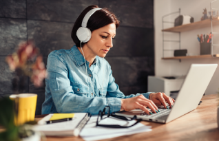 A transcriber reviewing timestamped and speaker-identified audio, ensuring accuracy for transcription services in Minnesota.