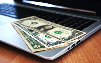 Dollar currency placed on a laptop