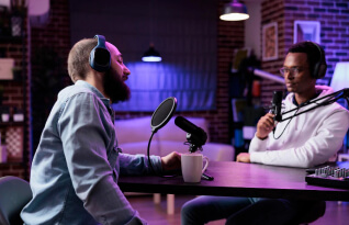 Two people sharing their experiences in a podcast
