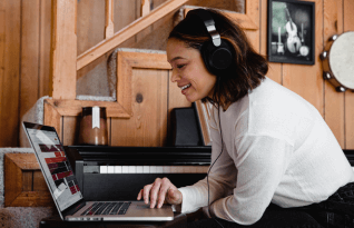 A woman wearing headphones reviewing a transcription