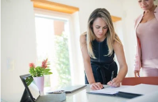 A customer signing a document with our support executive
