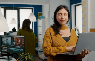  Woman looking at camera smiling working in media agency