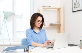 A qualified transcriber working on a laptop