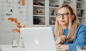 Woman-Using-Laptop-Wearing-Headphones