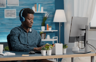 Young manager using headphones to transcribe content while working from home